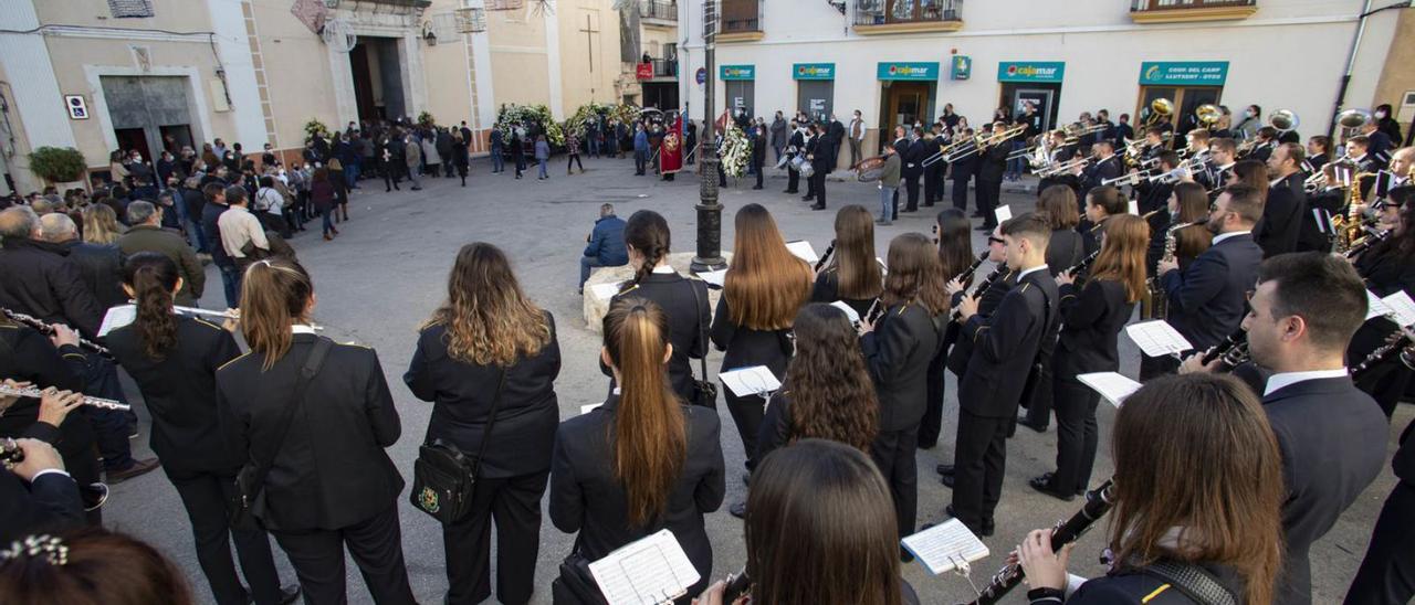 Los músicos de Llutxent y Ràfol despiden a su antiguo compañero en la entrada a la iglesia. | PERALES IBORRA