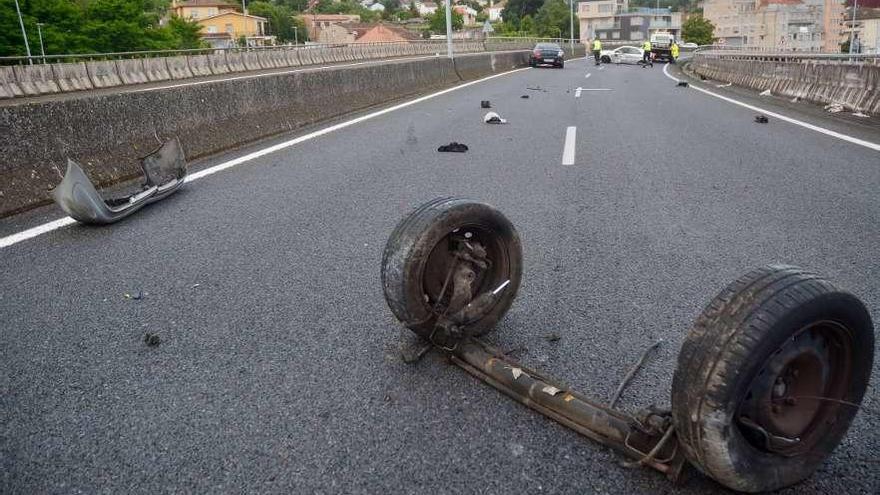 El eje que perdió uno de los coches implicados, que aparecen al fondo bloqueando el paso. // R. Vázquez