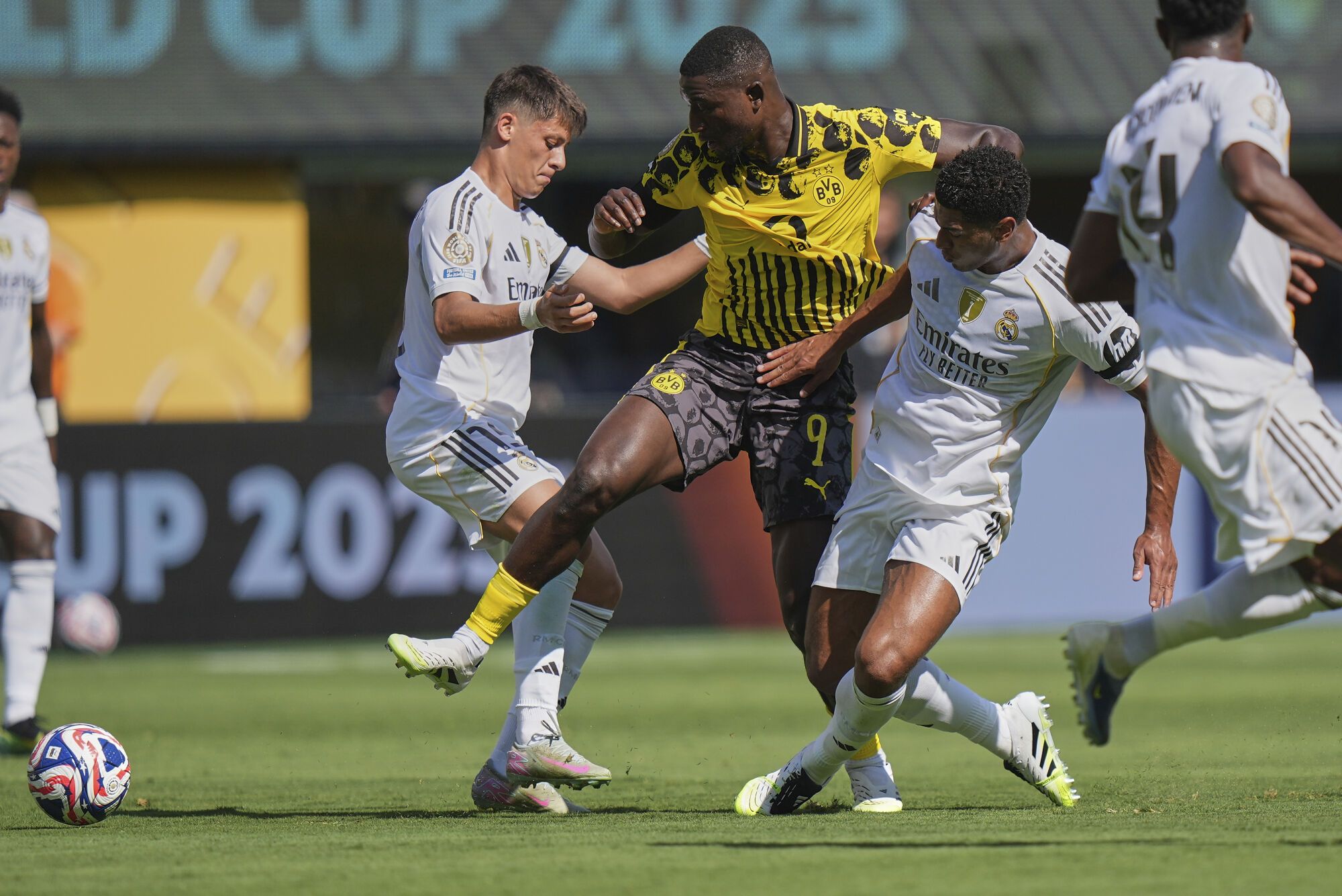 Borussia Dortmund's Serhou Guirassy and Real Madrid's Jude Bellingham vie for control of the ball during the first half of a Club World Cup quarterfinal soccer match, Saturday, July 5, 2025 in East Rutherford, N.J. (AP Photo/Frank Franklin II)