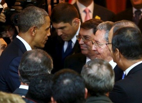 U.S. President Barack Obama talks with his Cuban counterpart Raul Castro before the inauguration of the VII Summit of the Americas in Panama City
