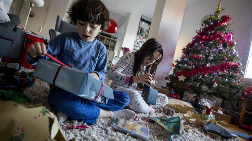 Unos niños valencianos abriendo regalos de Reyes.