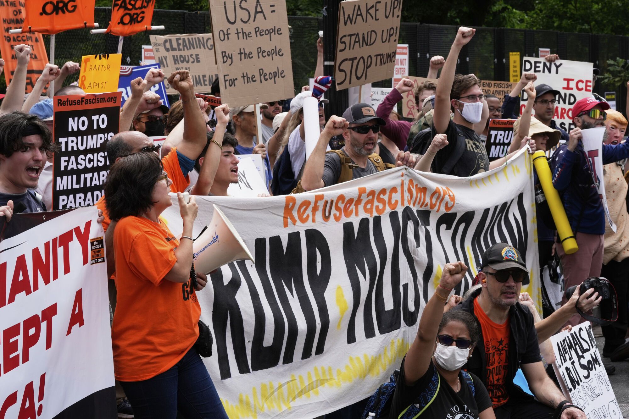 Demonstrators chant near the White House during a protest taking place on the day of a military parade commemorating the Army's 250th anniversary, coinciding with President Donald Trump's 79th birthday, Saturday, June 14, 2025, in Washington. (AP Photo/Alex Brandon)