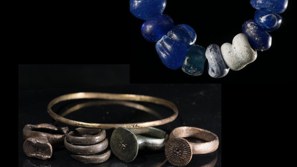 Una pulsera y anillos de bronce y un collar de vidrio