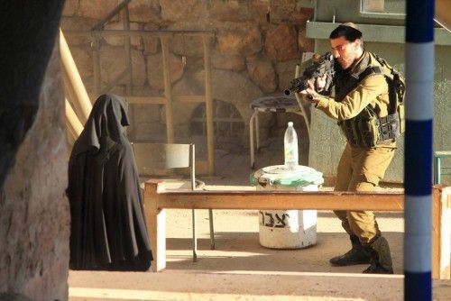 Israeli soldier aims rifle at woman said to be 19-year-old Palestinian student Hadeel al-Hashlamun, before she was shot and killed by Israeli troops, at an Israeli checkpoint in the occupied West Bank