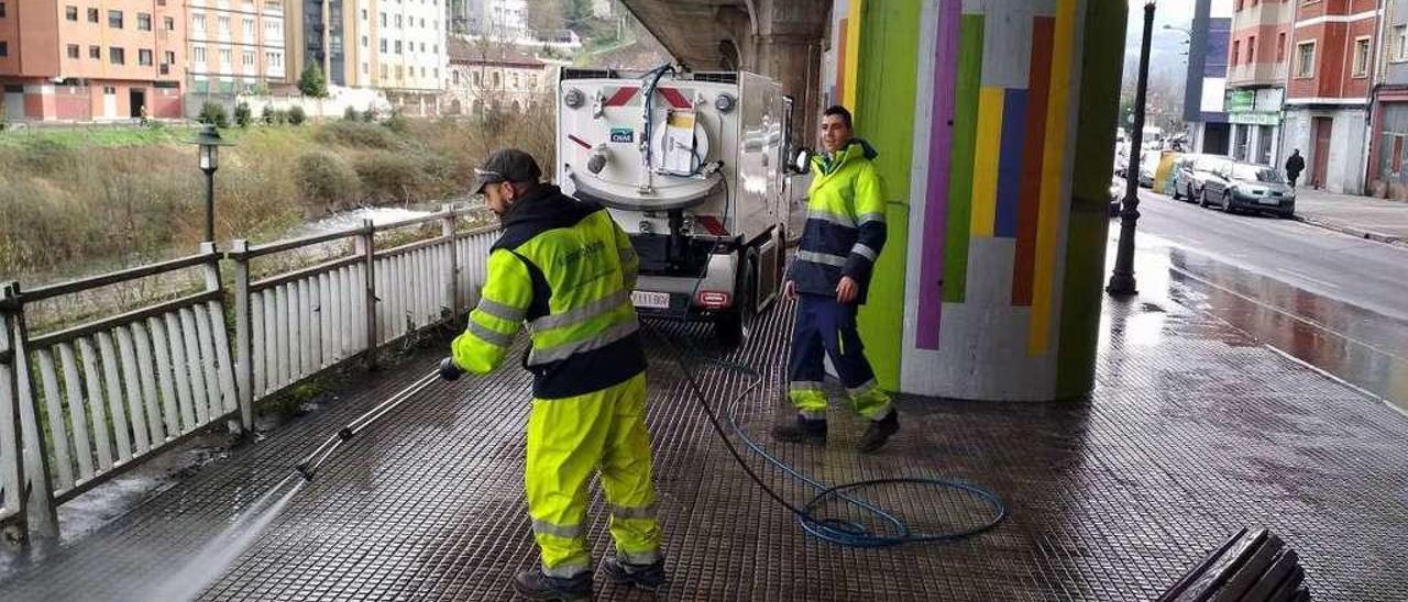 Trabajadores municipales, limpiando con la máquina decapadora de aceras.