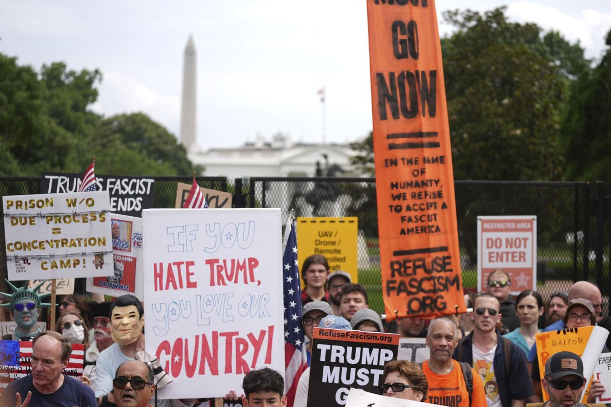 Demonstrators stand near the White House during a protest taking place on the day of a military parade commemorating the Armys 250th anniversary, coinciding with President Donald Trumps 79th birthday, Saturday, June 14, 2025, in Washington. (AP Photo/Evan Vucci)