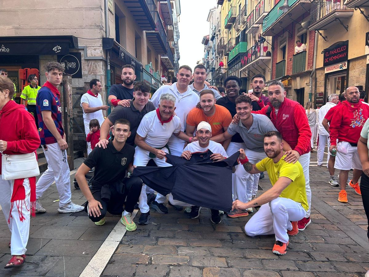 Pablo Gil (con la venda en la cabeza) y un grupo de amigos de Almassora posan tras el encierro con el polo que llevaba Pablo en la carrera.