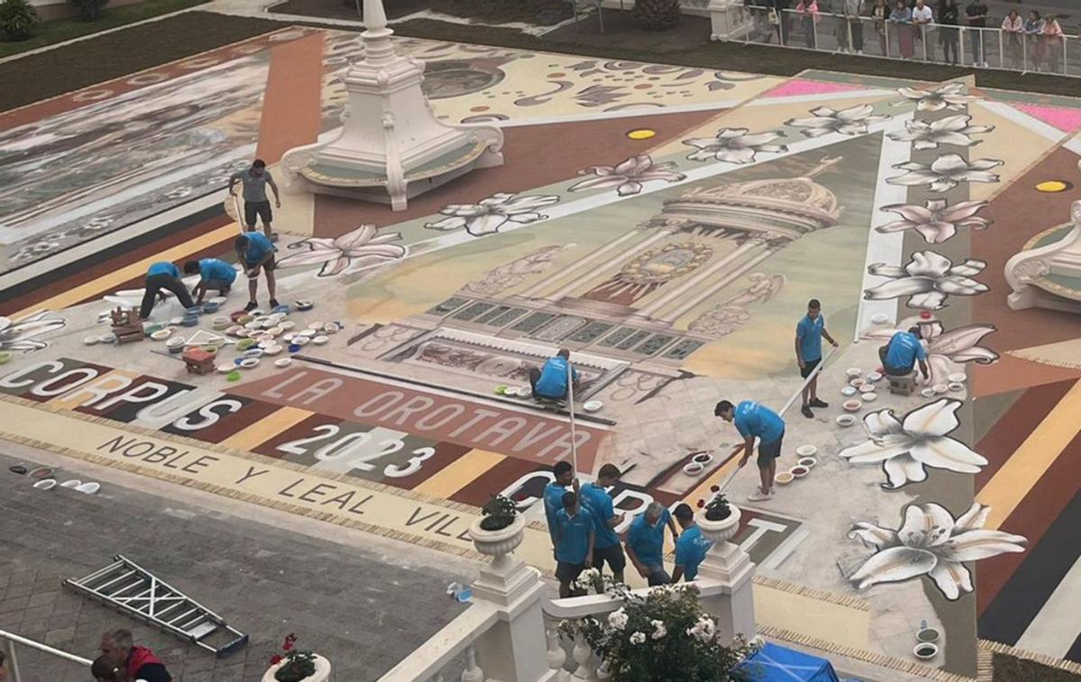 El equipo de trabajo de la alfombra de la plaza del Ayuntamiento, en plena faena, este miércoles. | | E.D.