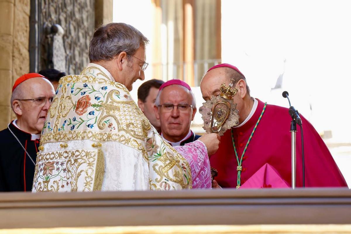 El obispo Jesús Fernández besando el 'lignun crucis' ofrecido por el presidente del Cabildo, Joaquín Alberto Nieva.