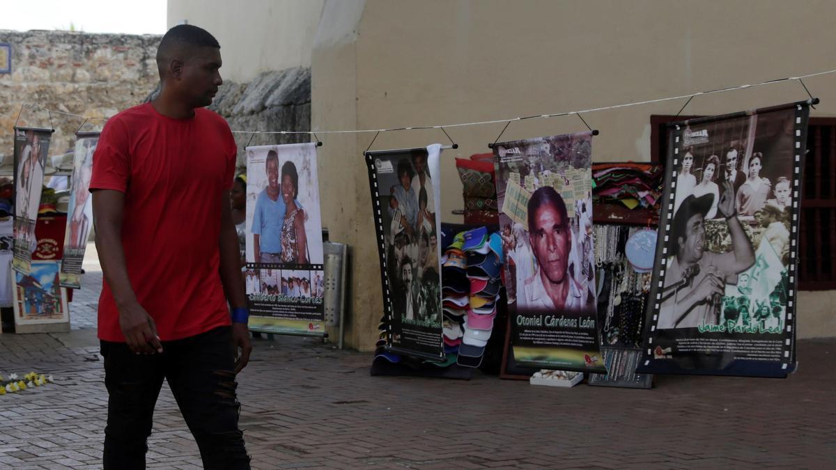 Un hombre observa una muestra de fotografías de líderes sociales asesinados o desaparecidos, en Cartagena.