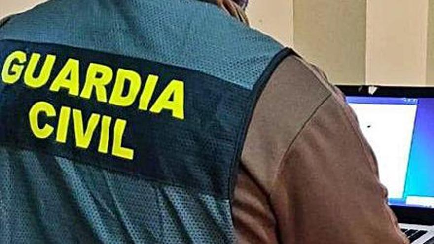 Un agente rastrea una estafa. | GUARDIA CIVIL