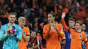 Bart Verbruggen y Virgil van Dijk, en primer término, y Frenkie de Jong detr5ás, agradecen al público su apoyo tras batir por 4-0 a Finlandia. 