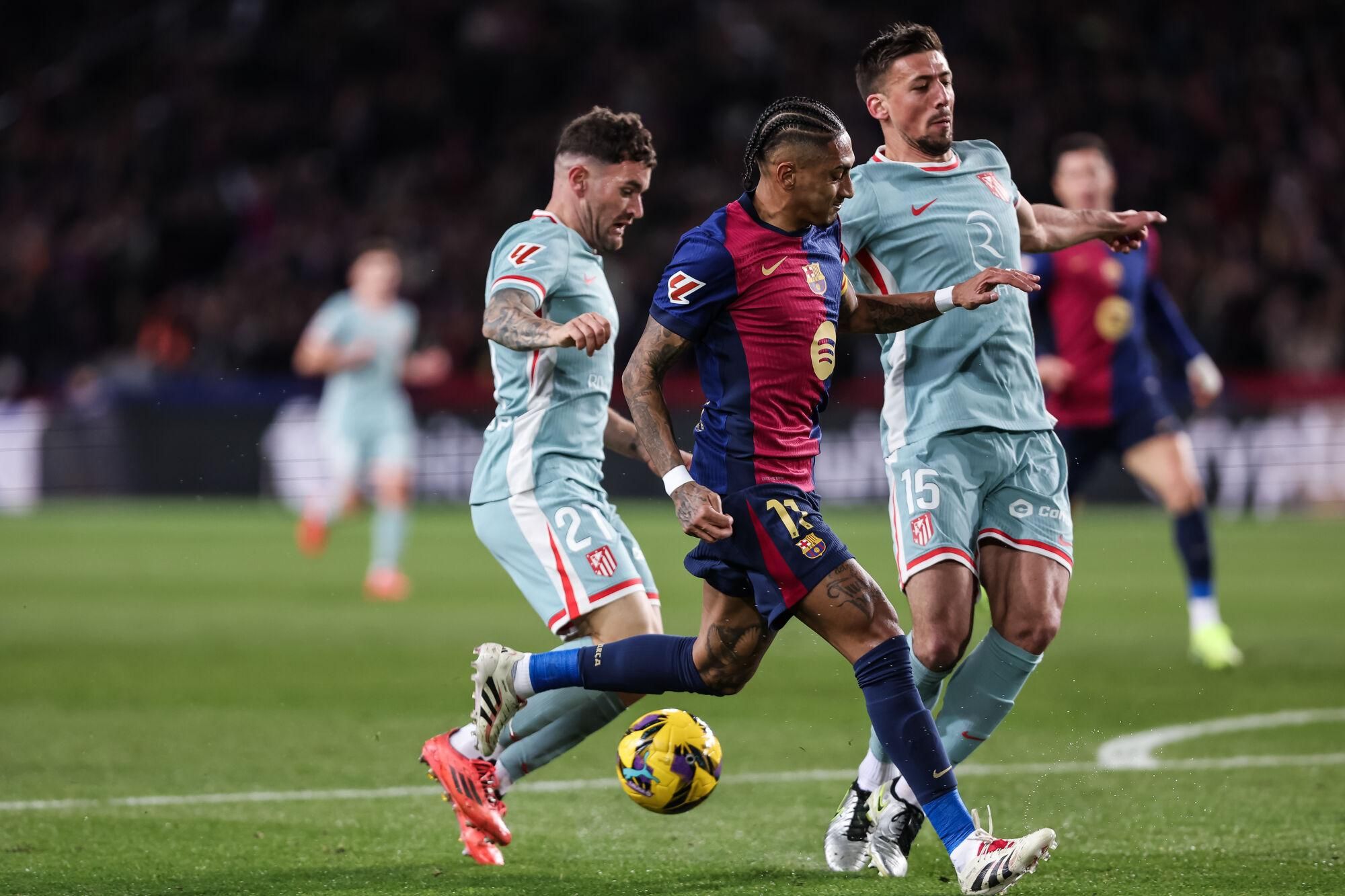 Raphinha Dias Belloli of FC Barcelona, Javi Galan and Clement Lenglet of Atletico de Madrid in action during the Spanish league, La Liga EA Sports, football match played between FC Barcelona and Atletico de Madrid at Estadio Olimpico de Montjuic on December 21, 2024 in Barcelona, Spain. AFP7 21/12/2024 ONLY FOR USE IN SPAIN. Javier Borrego / AFP7 / Europa Press;2024;SOCCER;SPORT;ZSOCCER;ZSPORT;FC Barcelona v Atletico de Madrid - La Liga EA Sports;