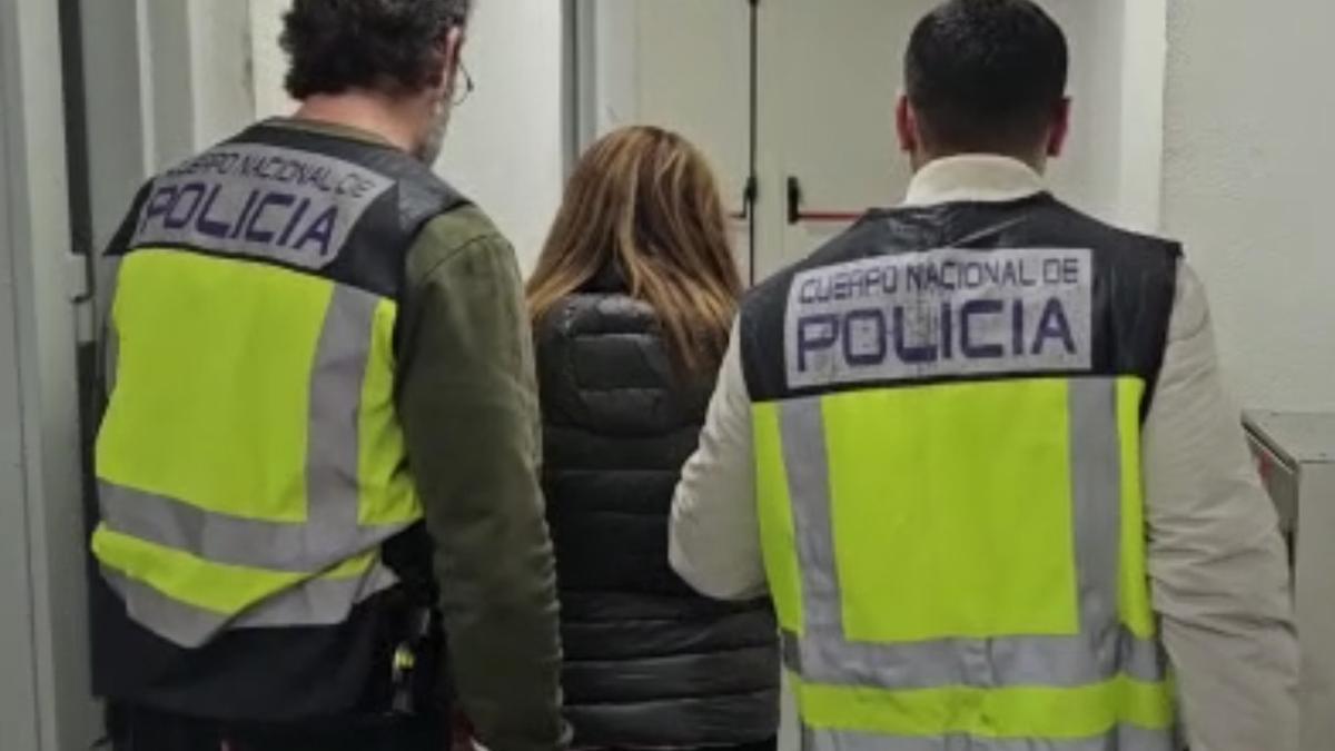 Agentes de la Policía Nacional llevan detenida a la mujer que, presuntamente, drogó a un anciano para robarle.