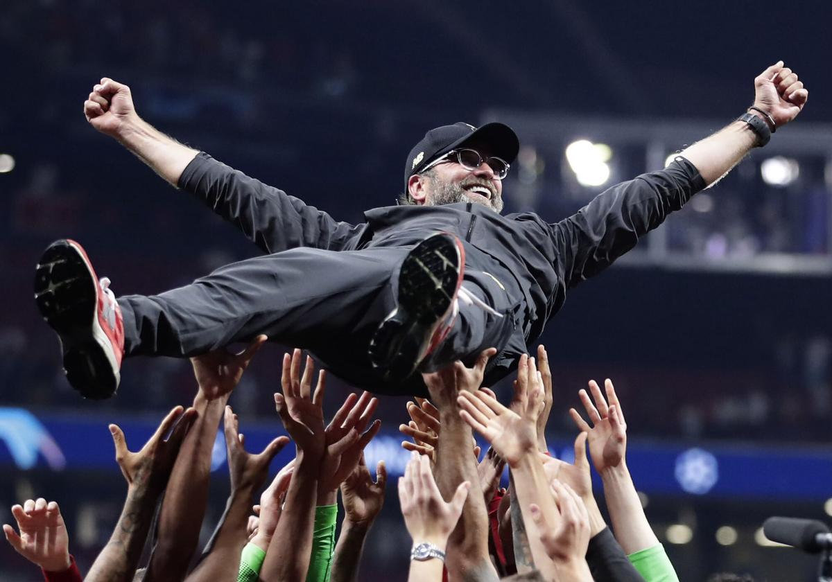 FILE - Liverpool coach Juergen Klopp is thrown into the air by player after winning the Champions League final soccer match between Tottenham Hotspur and Liverpool at the Wanda Metropolitano Stadium in Madrid, Saturday, June 1, 2019. Jurgen Klopp announced Friday Jan. 26, 2024, he will step down as Liverpool manager at end of this season. (AP Photo/Manu Fernandez, File). FILE PHOTO