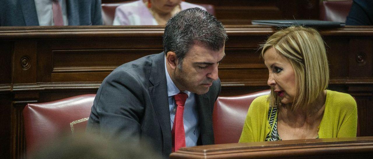 Manuel Domínguez, presidente del PP canario, charla con Australia Navarro en el pleno del Parlamento regional.