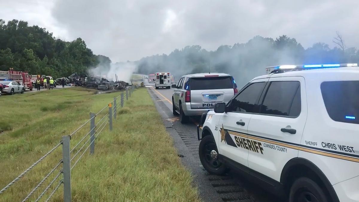 Smoke rises from the wreckage after about 18 vehicles slammed together on a rain-drenched Alabama highway during Tropical Storm Claudette, in Butler County, Alabama