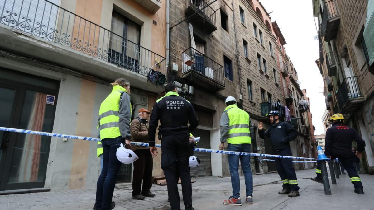 Efectius de la policia local, tècnics municipals i Bombers davant del bloc incendiat al carrer Santa Llúcia de Manresa