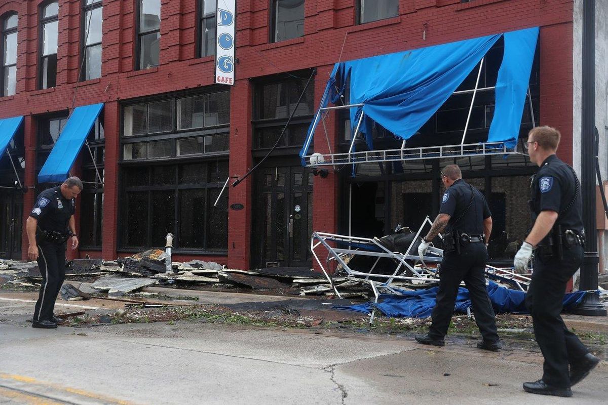 LAKE CHARLES, LOUISIANA - AUGUST 27: Lake Charles police officers help clear the roads in the downtown area after Hurricane Laura passed through on August 27, 2020 in Lake Charles, Louisiana . The hurricane hit with powerful winds causing extensive damage to the city.   Joe Raedle/Getty Images/AFP