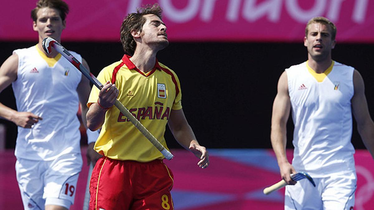 El español Álex Fábregas se lamenta ante los belgas Félix Denayer y Máxime Luycx, durante el partido por el quinto puesto en hockey sobre hierba