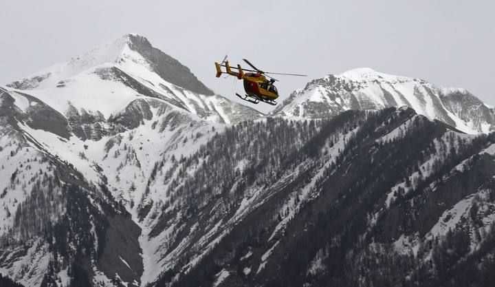 A rescue helicopter from the French Securite Civile flies over the French Alps during a rescue operation following the crash of an Airbus A320