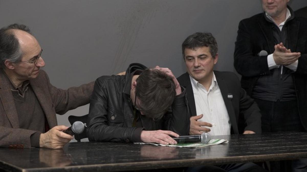 Satirical French magazine Charlie Hebdo new editor in chief Briard and columnist Pelloux comfort cartoonist Luz during a news conference at the French newspaper Liberation offices