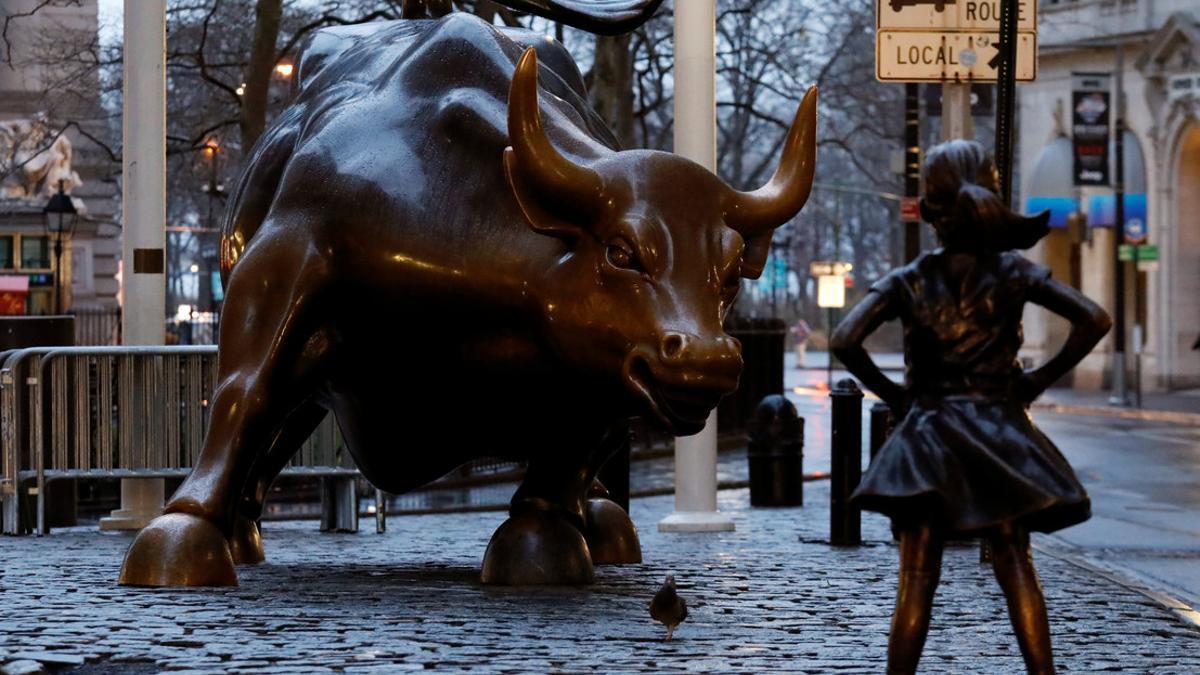 A statue of a girl facing the Wall St. Bull is seen in the financial district in New York