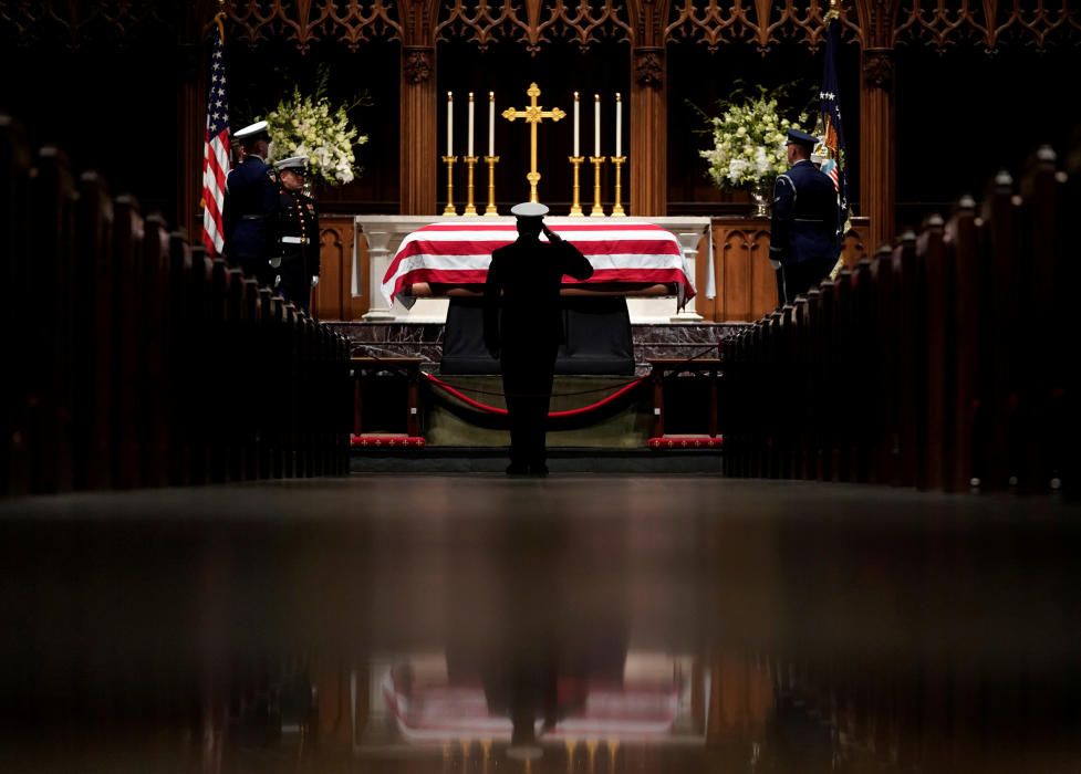 People pay their respects as the flag-draped ...