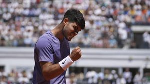 Spains Carlos Alcaraz celebrates after a winning point during a round of sixteen match against Russias Karen Khachanov at the Italian Open tennis tournament in Rome, Tuesday, May 13, 2025. (AP Photo/Andrew Medichini)