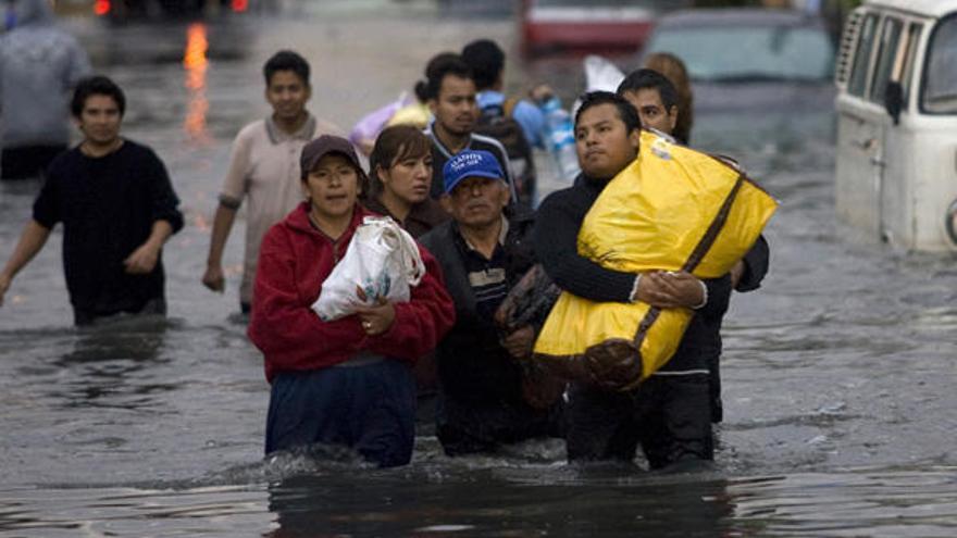 Habitantes de México D.F recorren las calles inundadas.