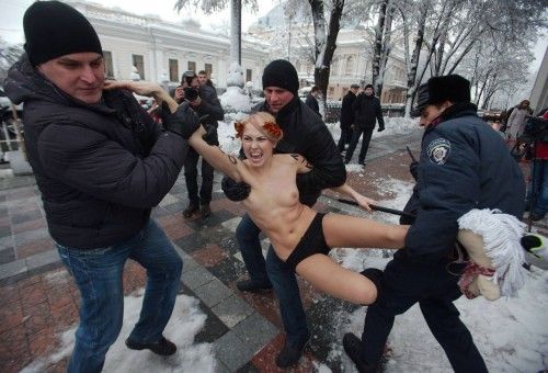 Security personnel detain activist from women's rights group Femen as Ukrainian parliament holds first session in Kiev