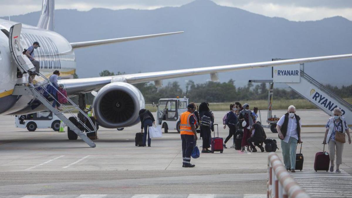 Passatgers baixant d’un avió de Ryanair a Vilobí