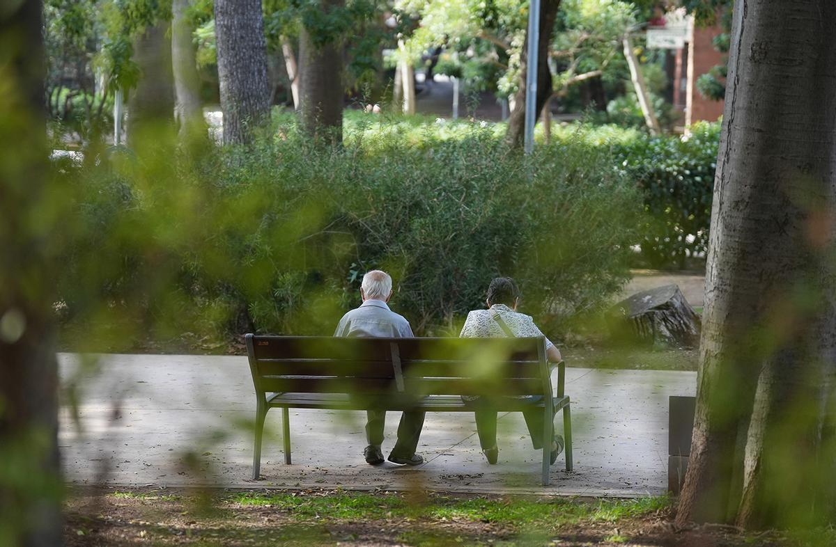 Dos personas mayores sentadas en un parque