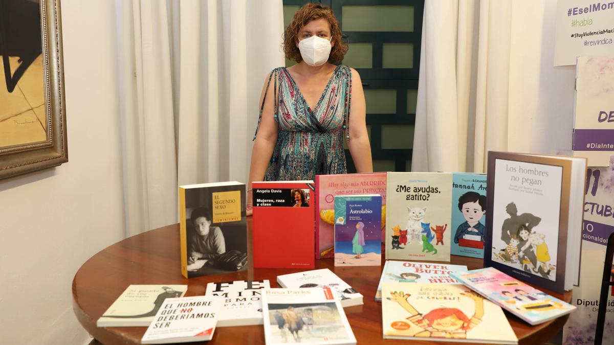 La delegada de Igualdad de la Diputación muestra el lote de libros.