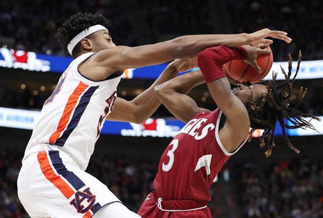 Terrell Brown # 3 de New Mexico State Aggies lanza a canasta contra Anfernee McLemore # 24 de los Auburn Tigers durante la segunda mitad de la primera ronda del Torneo de Baloncesto Masculino NCAA 2019 en el Vivint Smart Home Arena.