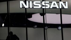 FILE PHOTO  A man is silhouetted at a show room of Nissan Motor Co  in Tokyo  Japan  February 12  2019  REUTERS Kim Kyung-hoon File Photo