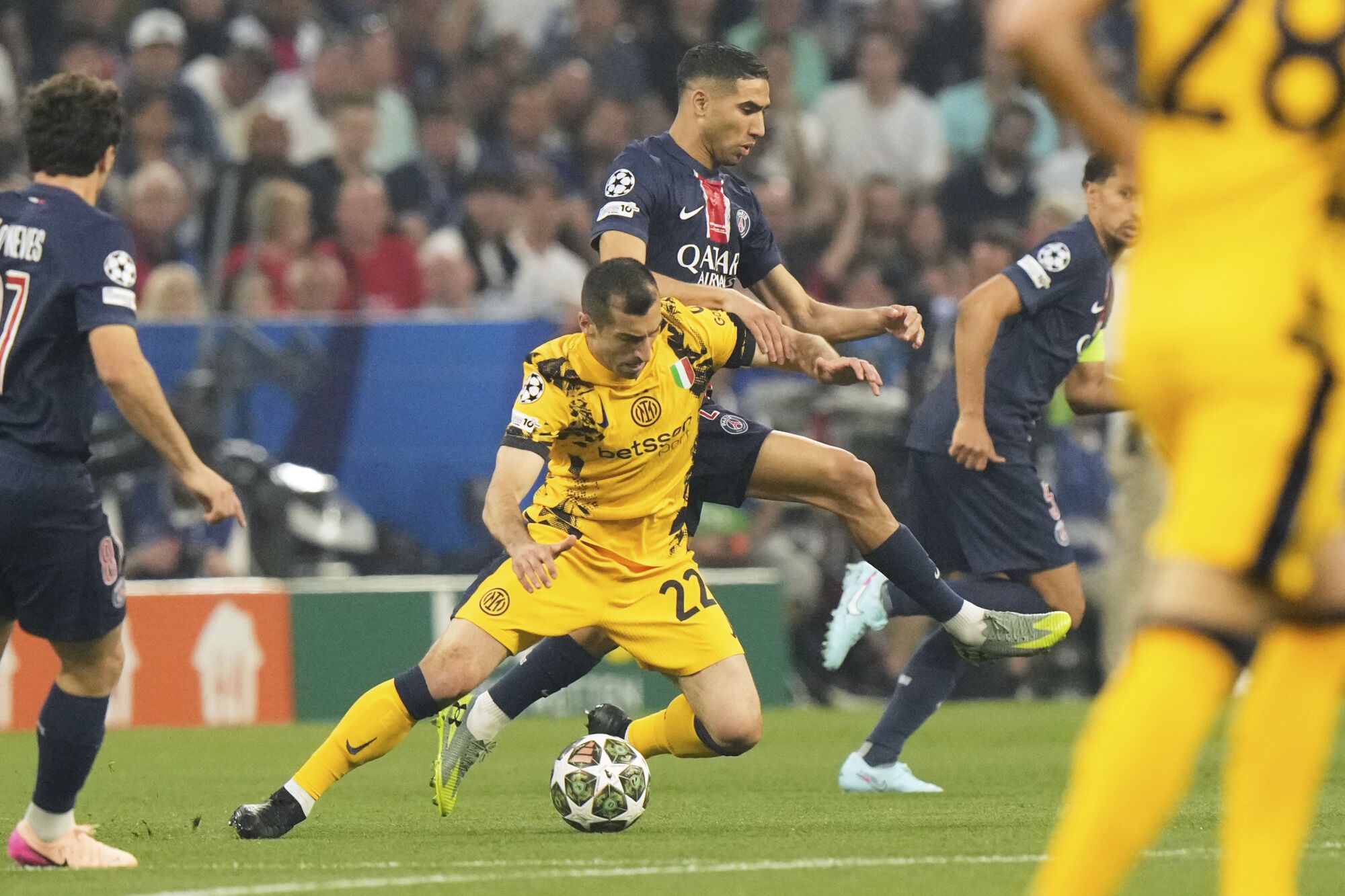 PSG's Achraf Hakimi, background, fights for the ball with Inter Milan's Henrikh Mkhitaryan during the Champions League final soccer match between Paris Saint-Germain and Inter Milan at the Allianz Arena in Munich, Germany, Saturday, May 31, 2025. (AP Photo/Luca Bruno). EDITORIAL USE ONLY / ONLY ITALY AND SPAIN