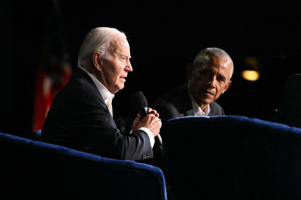 US President Joe Biden (L) speaks next to former US President Barack Obama onstage during a campaign fundraiser at the Peacock Theater in Los Angeles on June 15, 2024. (Photo by Mandel NGAN / AFP)