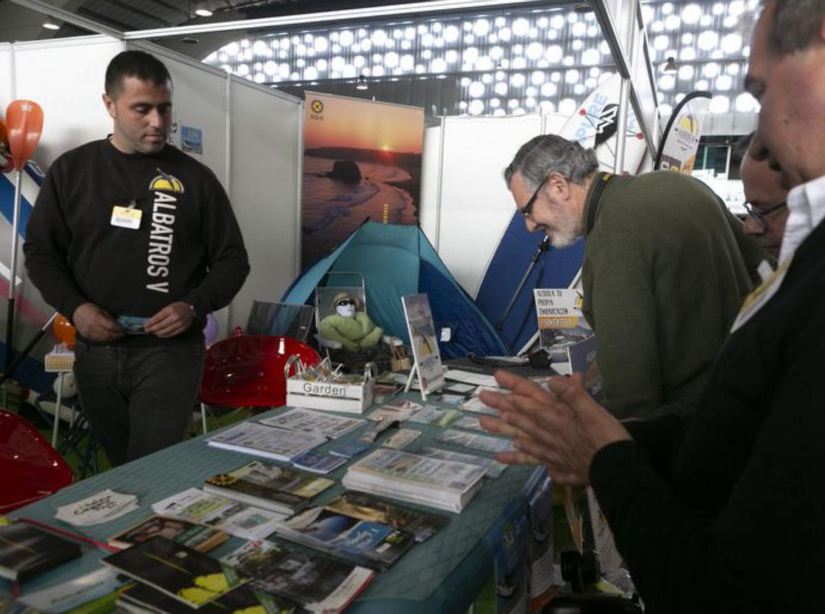 Por la izquierda, Daniel González, Graciela Blanco, José Manuel Vega (director de zona de Caja Rural), Raquel Ruiz, Celia Fernández (vicepresidenta de la Junta General del Principado) y, al fondo, José Luis Álvarez Almeida y Laura Arias, durante el recorrido institucional. A la derecha, visitantes mirando folletos informativos. | María Fuentes