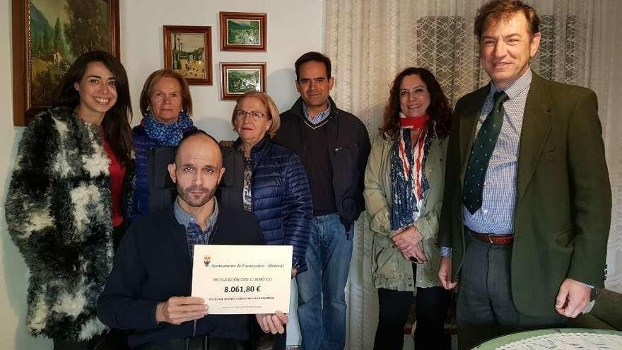 Luis con el cheque rodeado de las voluntarias de San Vicente de Paúl, el alcalde saucano y miembros de PAAT.
