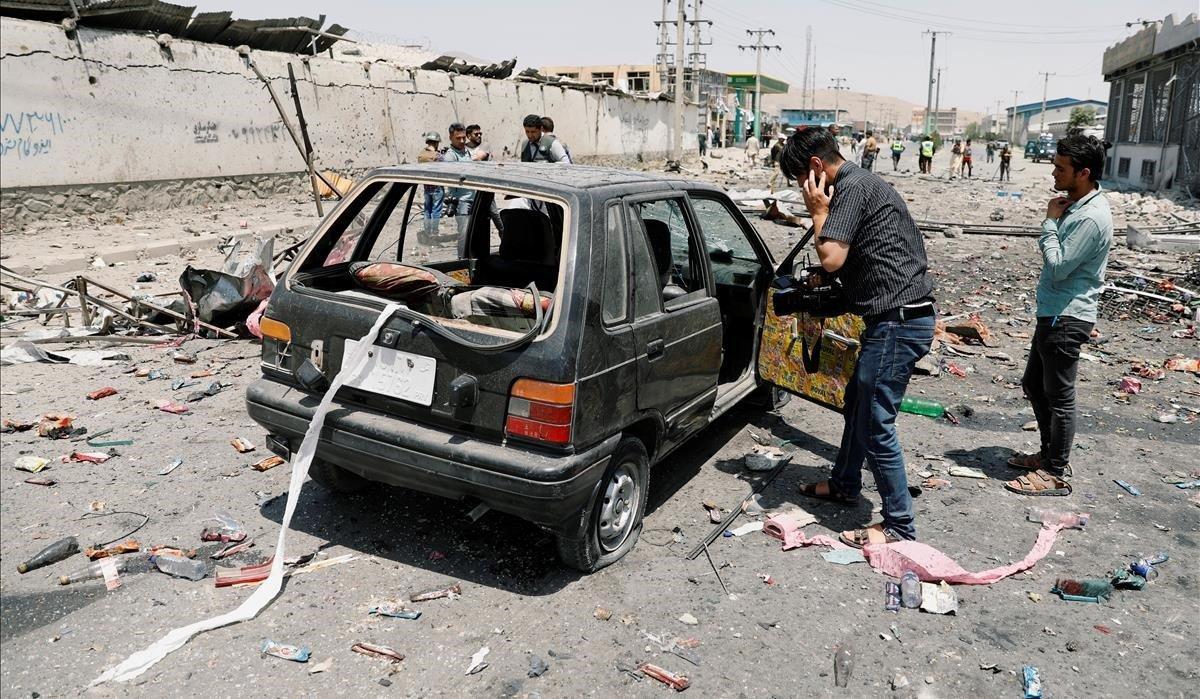 zentauroepp49208361 a cameraman films a damaged car at the site of a blast in ka190725124244