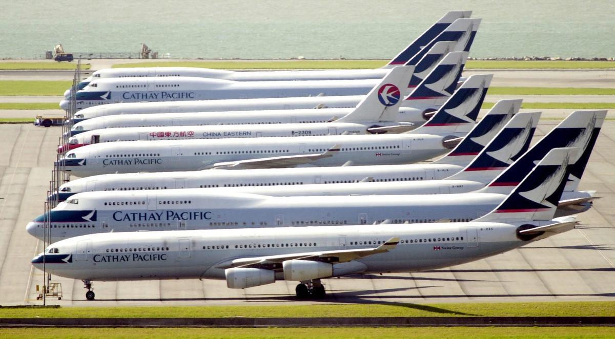 Cathay Pacific Airways planes taxi at Hong Kong’s International Airport Tuesday, July 10, 2001. The Airways canceled 29 out of 143 flights, one day after firing 49 pilots in an ongoing labor dispute that has delayed thousands of passengers. The plane in between is belongs to China Eastern airline. (AP Photo/Vincent Yu)