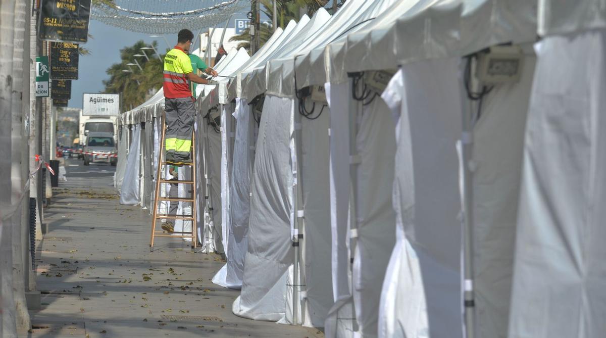 Dos trabajadores ultiman la colocación de las carpas en la avenida de Canarias de Vecindario, en el municipio de Santa Lucía, ayer. | | JUAN CASTRO