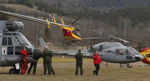 Rescue helicopters from the French Securite Civile and the Air Force are seen in front of the French Alps during a rescue operation near the crash site of an Airbus A320