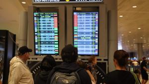 Pasajeros consultan el panel de salidas de vuelos en el aeropuerto de Ben Gurión, en Tel Aviv.