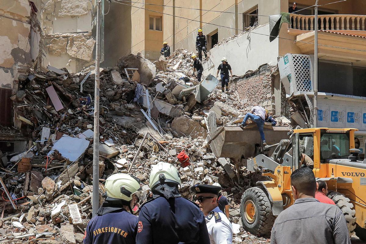 Los socorristas de defensa civil buscan entre los escombros en la escena de un edificio derrumbado de 13 pisos en el distrito de Sidi Bishr de la ciudad de Alejandría, en el norte de Egipto.