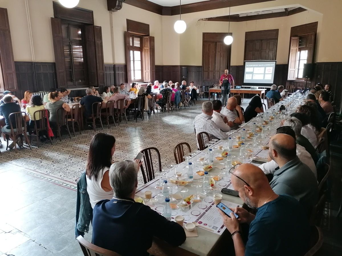 Díez, de pie, explica a los participantes en el taller cómo elaborar cócteles con vino