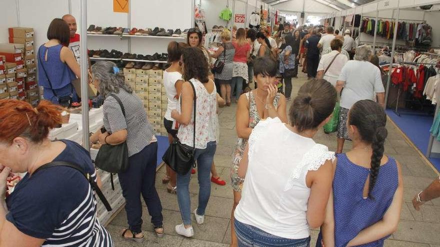 Primeros visitantes del salón realizando sus compras. // Santos Álvarez