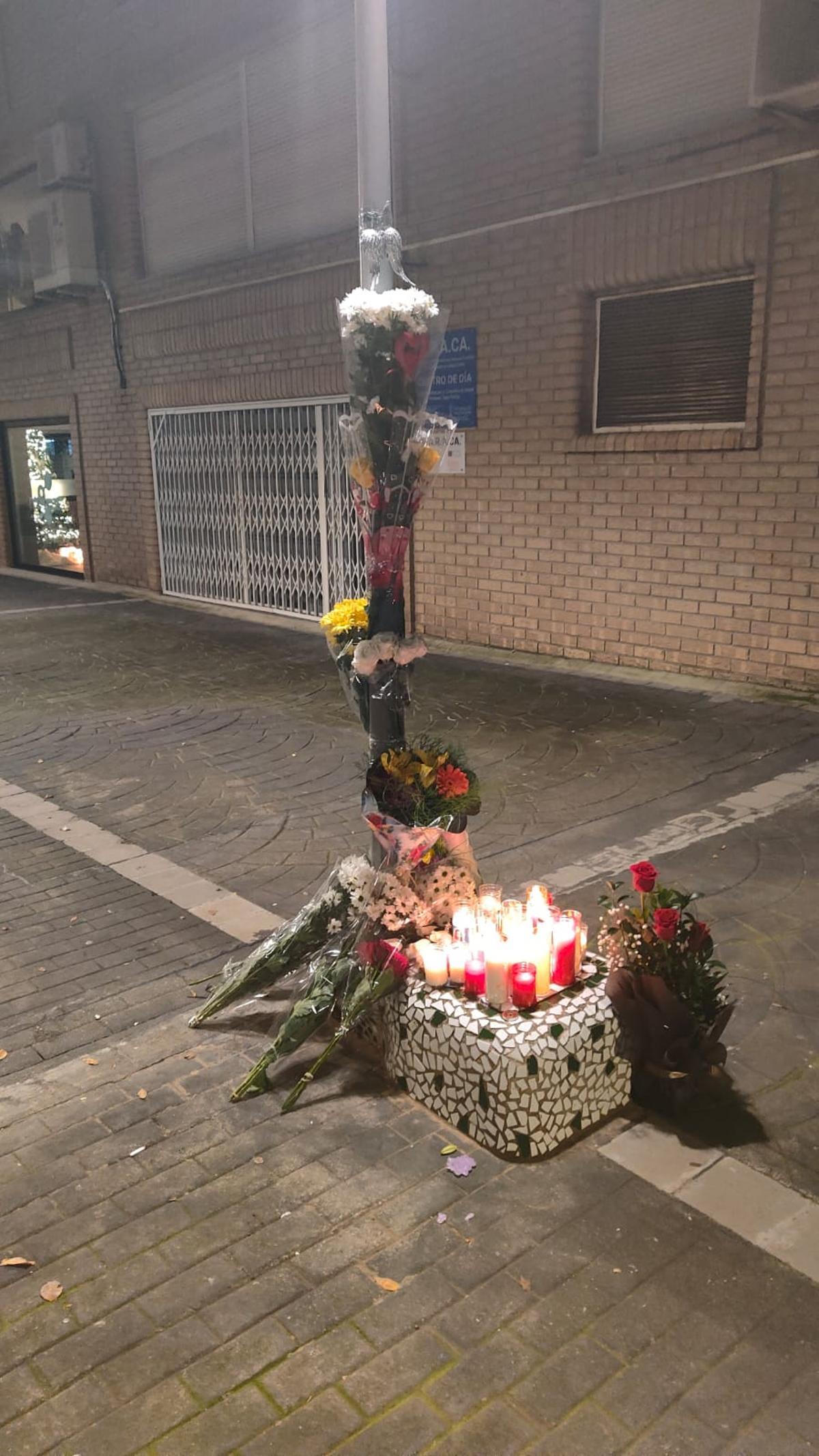 Imagen del altar improvisado con flores y velas.