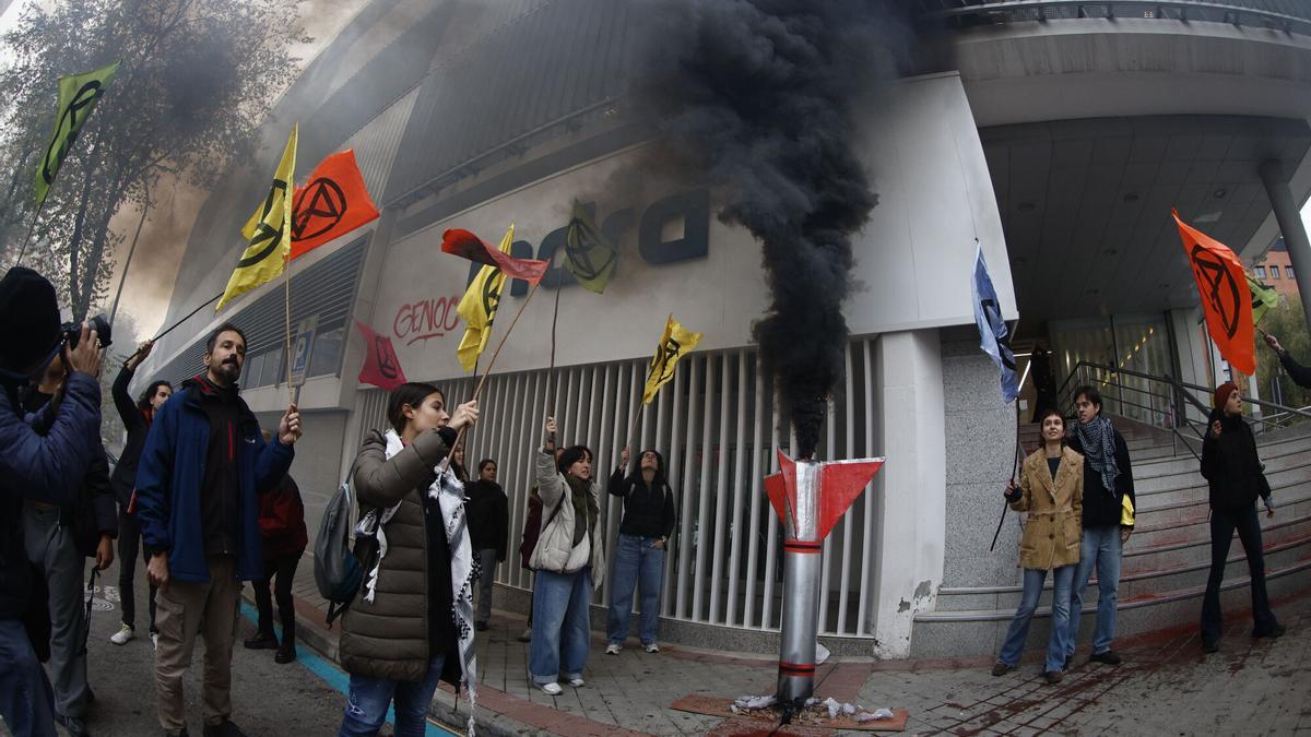 Activistas del grupo Rebelión o Extinción protestan este lunes ante la sede de Indra en Madrid.
